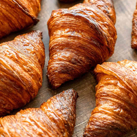 Golden, flaky croissants baked fresh for corporate breakfasts and large event catering orders at BAEKRI Dubai