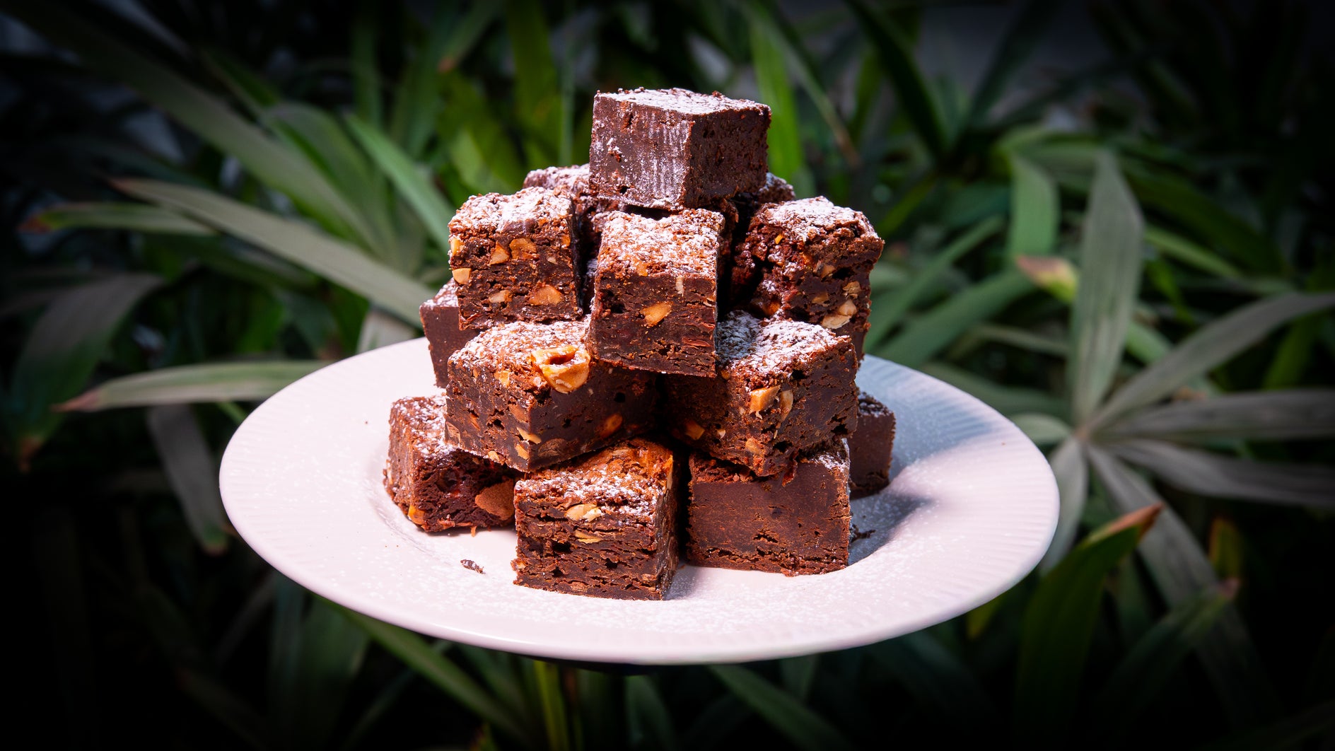 A stacked pyramid of rich, fudgy chocolate brownies dusted with icing sugar at Bae-Kri.
