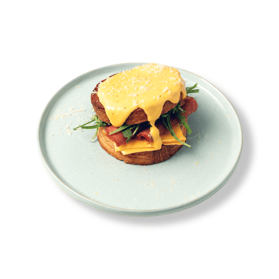 Flaky golden circular New York Roll croissant stuffed with premium ham and melted cheese