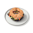 Toasted golden sesame crusted simit sandwich filled with premium smoked salmon ribbons cream cheese capers and dill